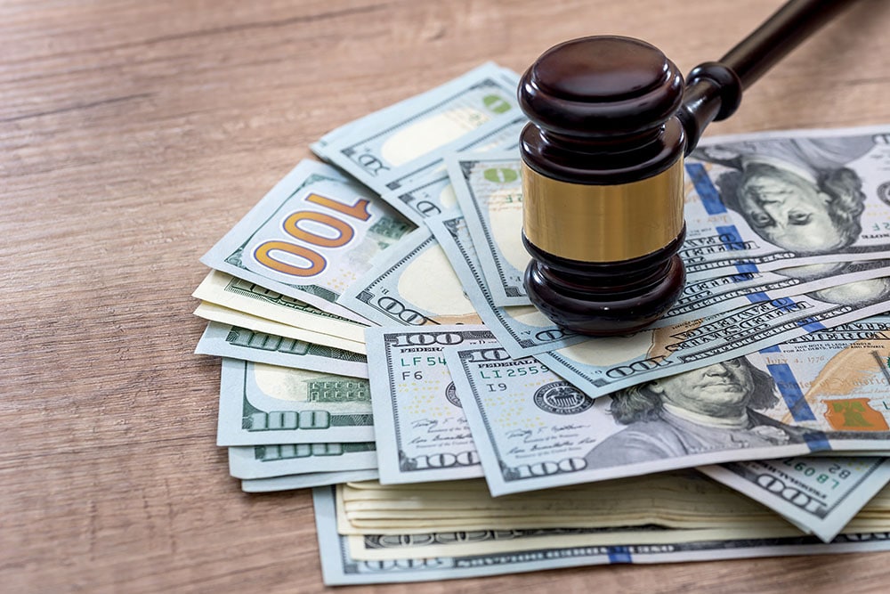 wooden gavel with usa dollar on desk. close up.