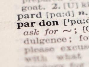 Dictionary definition of word pardon, selective focus.
