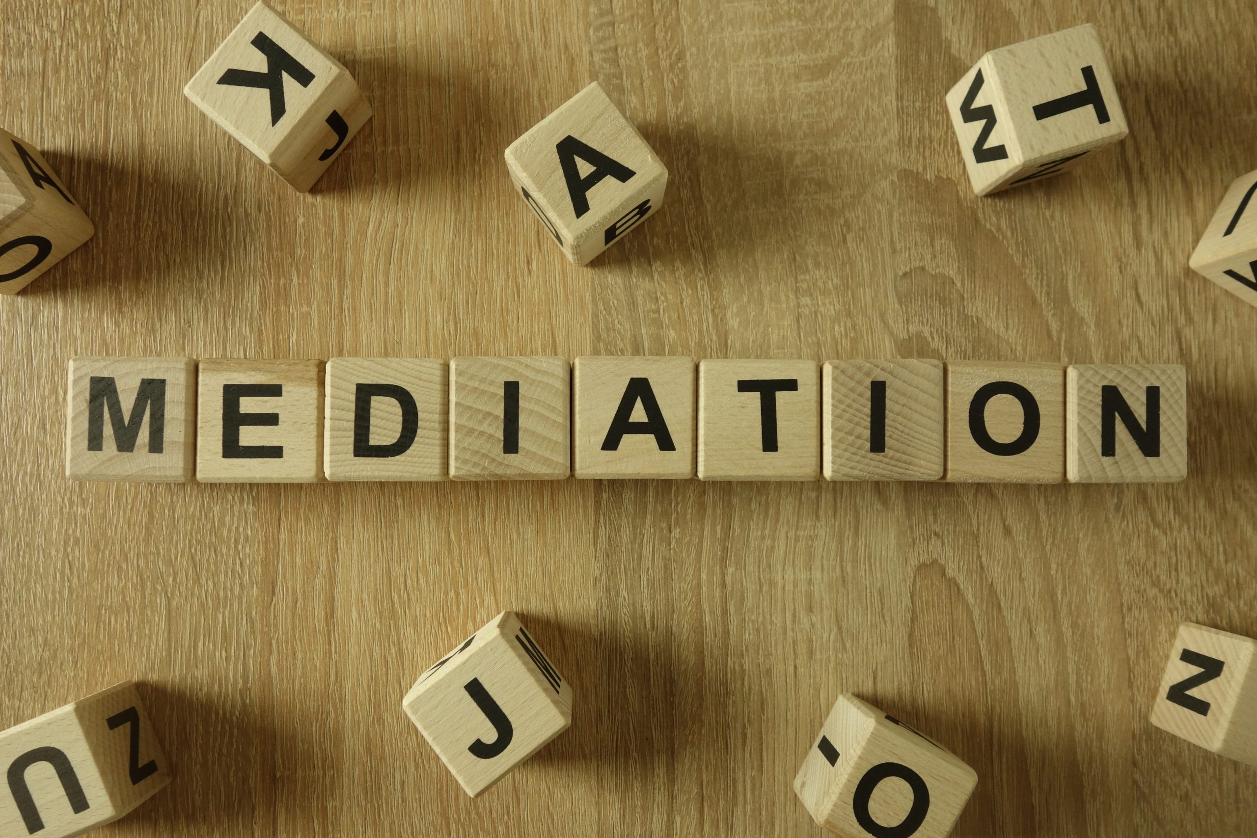 Mediation word from wooden blocks on desk