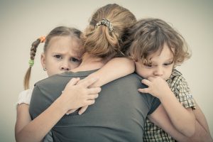 sad children hugging his mother