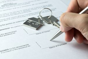 Man signing sale and purchase agreement at purchaser column