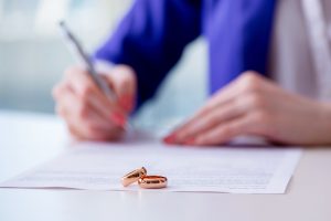 Woman signing prenuptial agreement in court