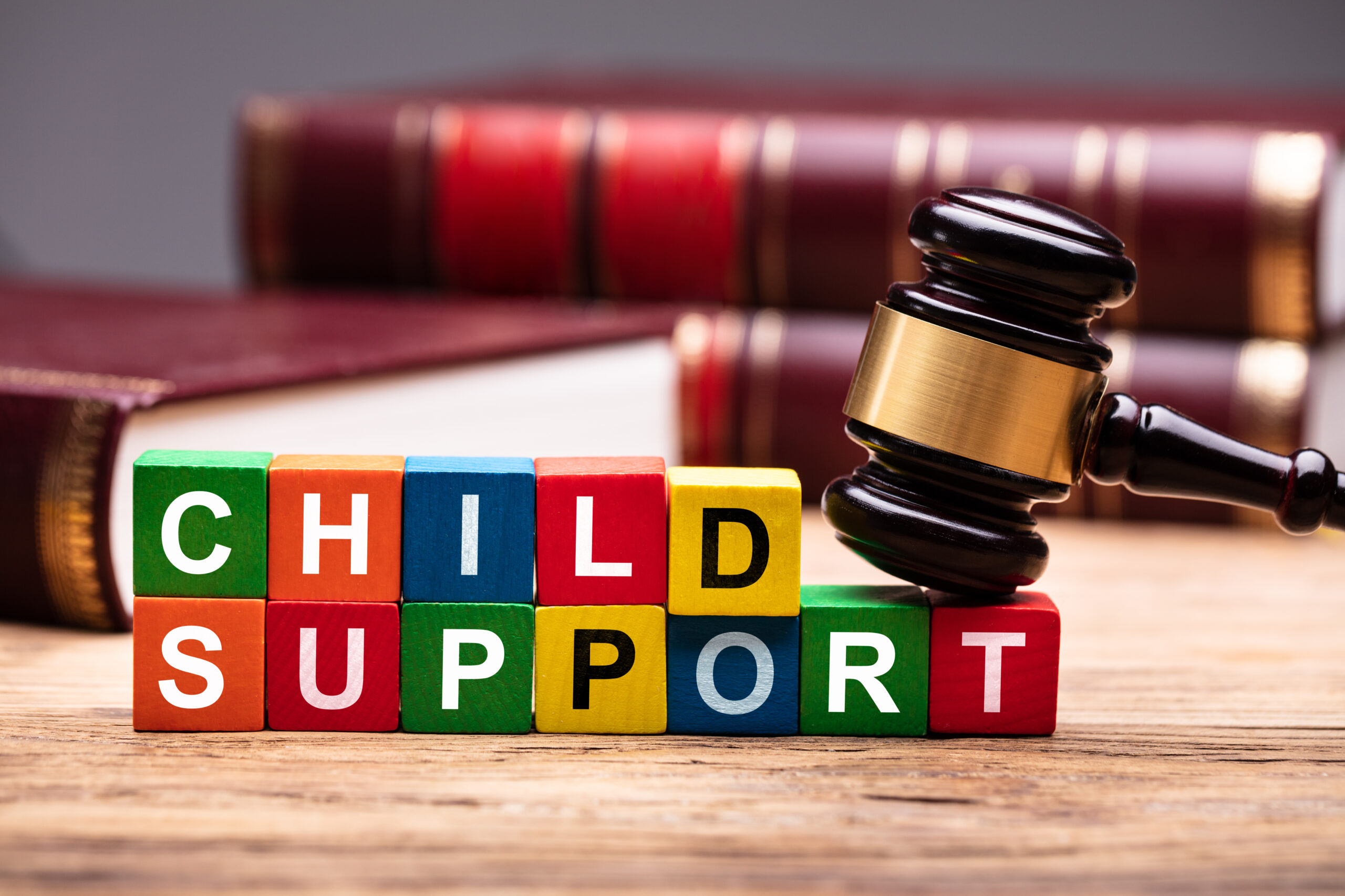 Child Support Colorful Block With Bible And Hammer Over Wooden Desk In Courtroom