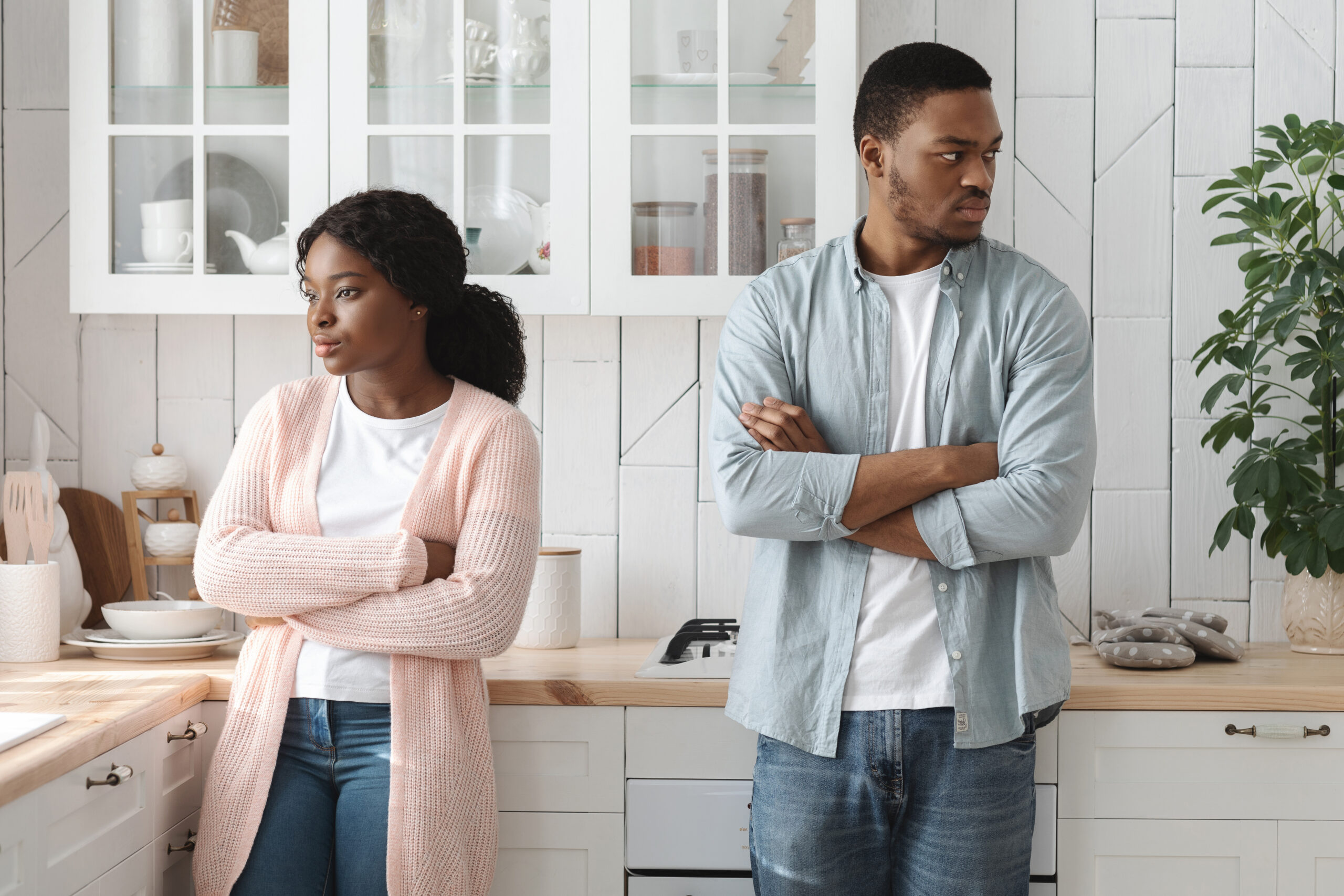 Relationship Crisis. Offended Young Angry African American Spouses Standing In Kitchen After Quarrel, Ignoring Each Other, Black Millennial Couple Suffering Misunderstanding In Relations, Free Space