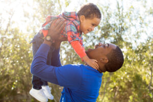 Cute father and son playing together at the park