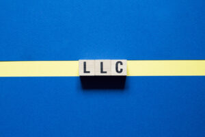 LLC - Limited Liability Company,word concept on cubes.