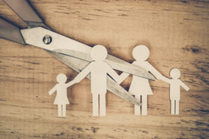 Scissors cutting paper cut of family / Broken family concept / d