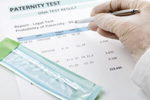 Paternity DNA test result chart form - doctor pointing at result value
