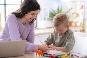 Mother and son smiling doing homework